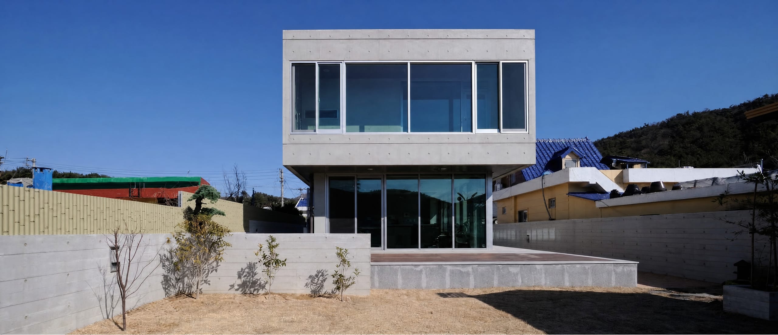 Completed concrete house with a projecting glazed corner window