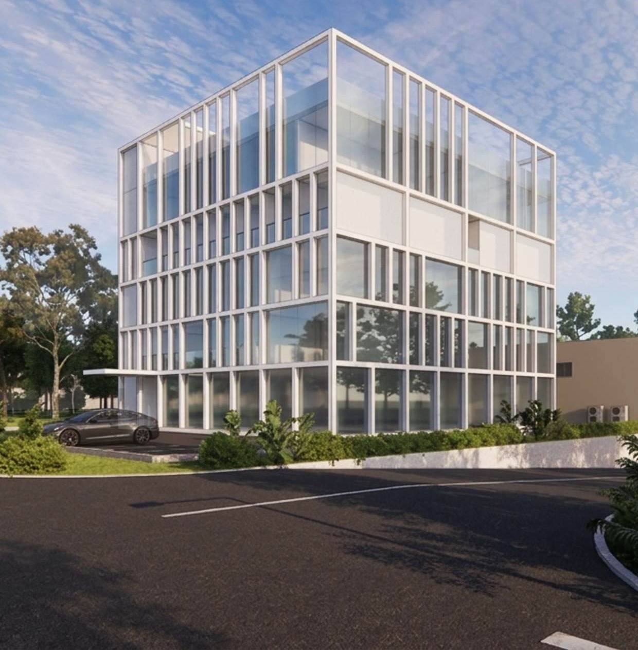 Glazed office volume wrapped in a white structural grid