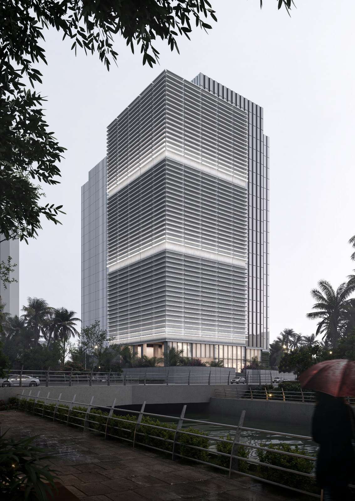Louvred office tower beside a riverside walkway at dusk