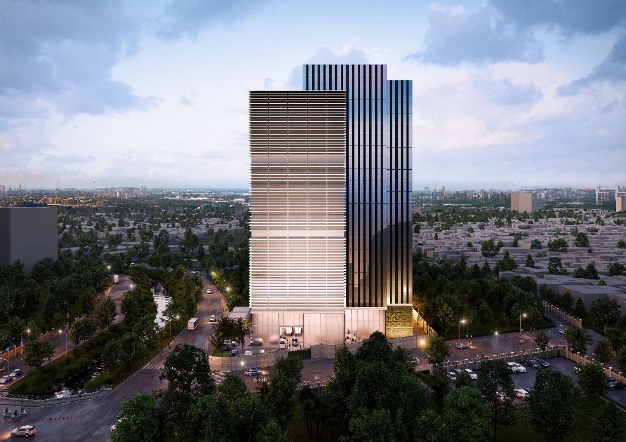 Two-tone corporate tower above a low-rise city skyline at dusk